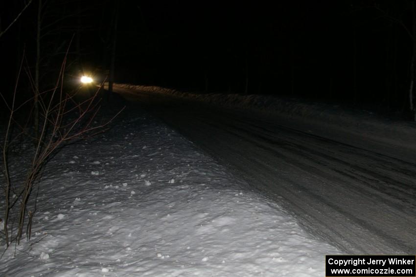 A car comes into the finish of the Hungry 5 stage at night.