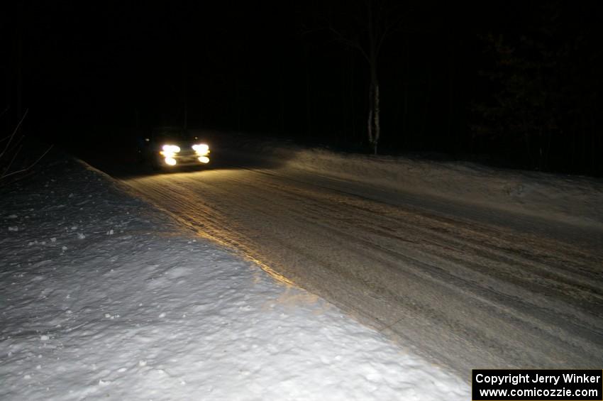 A car comes into the finish of the Hungry 5 stage at night.