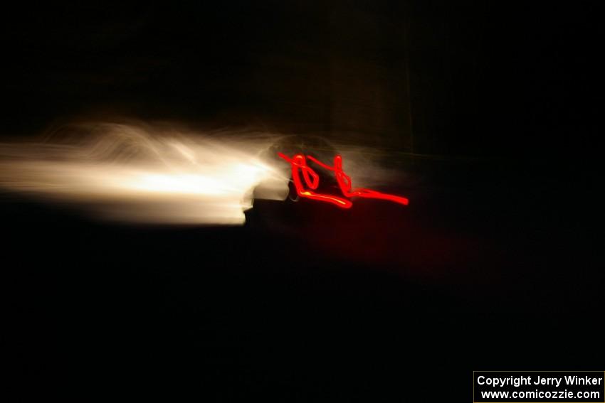 A car crosses the finish of Hungry 5 at night.