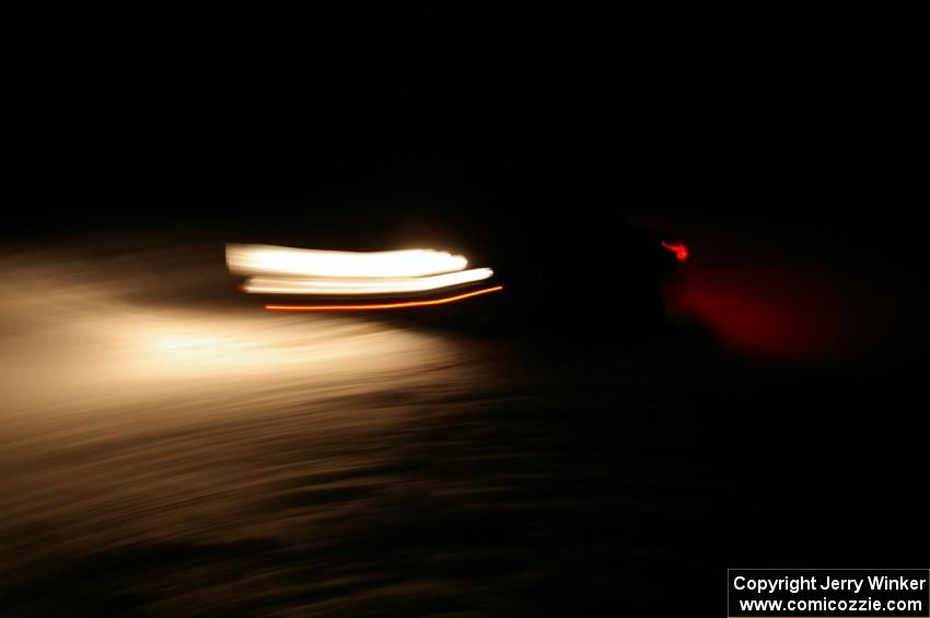 A car crosses the finish of Hungry 5 at night.