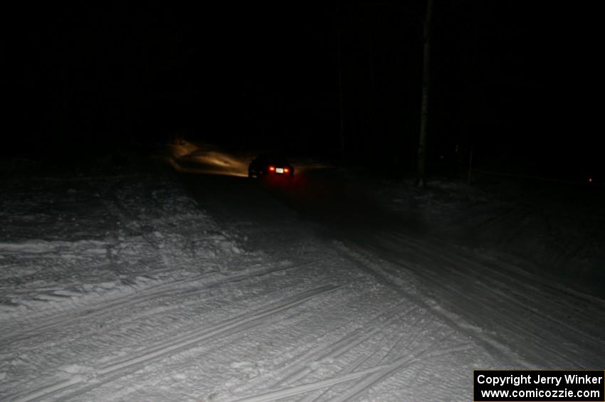 A car crosses the finish of Hungry 5 at night.