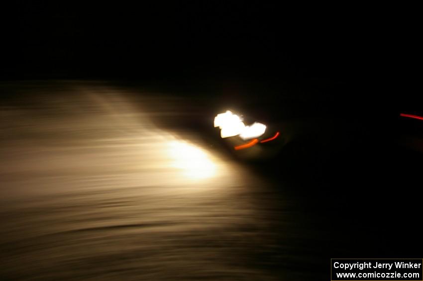 A car crosses the finish of Hungry 5 at night.