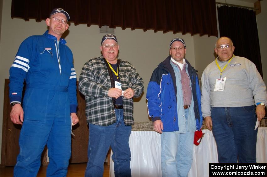 Dave Parps (L) and eventmaster Don Rathgeber (R) pose with workers who won the Greer Tire raffle.