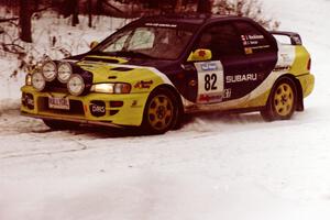 The Joan Hoskinson / Jeff Secor Subaru Impreza 2.5RS sets up for a hard-right on a stage near the end of the rally.