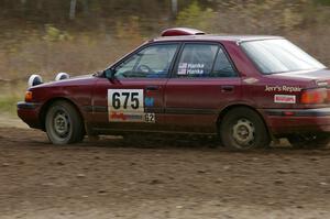 Ben Hanka / Greg Hanka Mazda Protege enters the Parkway Forest Rd. chicane.