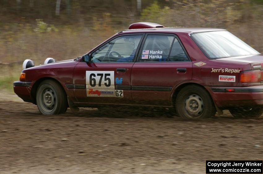 Ben Hanka / Greg Hanka Mazda Protege enters the Parkway Forest Rd. chicane.