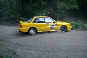 Erik Payeur / Adam Payeur Mitsubishi Galant clips the inside of a hairpin too close on SS1 and gets hung up on a boulder.