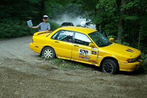 The stuck Erik Payeur / Adam Payeur Mitsubishi Galant flashes the OK sign to the Ryan Johnson / Matt Himes Saturn SL2.