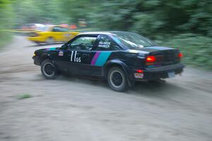 Jason Beck / Harry Beck Pontiac Sunbird at speed on SS1 as the Erik Payeur / Adam Payeur Mitsubishi Galant gets turned around.