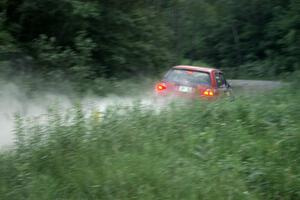 Paul Koll / Matt Wappler VW GTI at speed on a straight on SS2 at sundown.