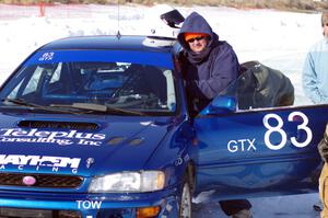 Mark Utecht climbs into the driver's seat of the #83 Subaru Impreza 2.5RS