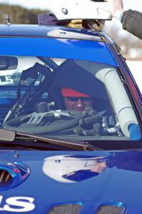 Mark Utecht straps into the driver's seat of the #83 Subaru Impreza 2.5RS