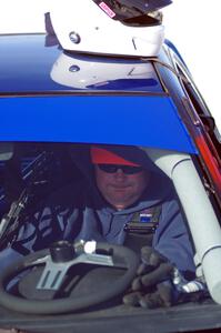 Mark Utecht straps into the driver's seat of the #83 Subaru Impreza 2.5RS