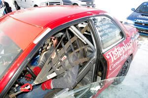 Brent Carlson straps into the driver's seat of the #84 Subaru Impreza