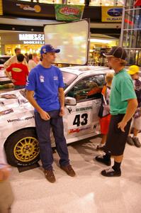 Travis Pastrana talks to a fan in front of the Ken Block / Alex Gelsomino Subaru WRX STi.