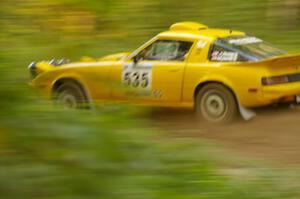 Jake Himes / Matt Himes Mazda RX-7 at speed down a straight on Halverson Lake, SS1.