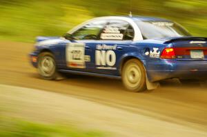 Dennis Martin / Kim DeMotte Saturn SL2 at speed down a straight on Halverson Lake, SS1.