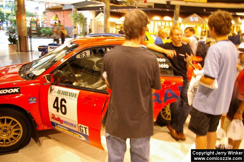 Rally fans check the inside of the Matthew Johnson / Wendy Nakamoto Subaru WRX at Rallyfest at the Mall of America.