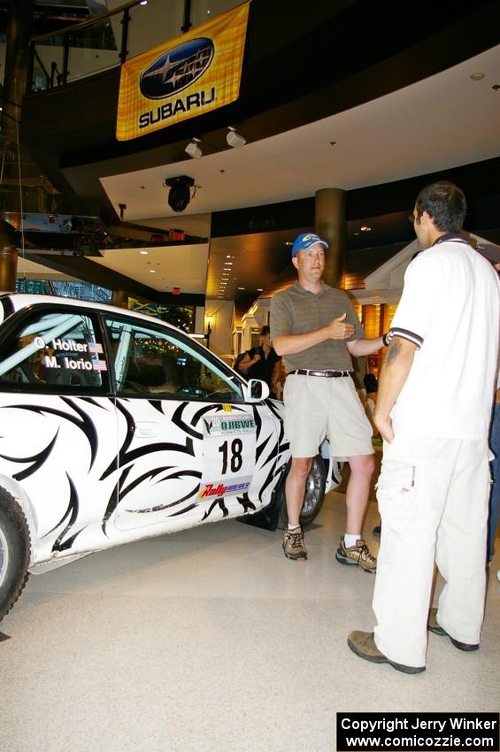 Matt Iorio discusses his Subaru Impreza to new rally fans at the Mall of America. Ole Holter was his navigator for the weekend.