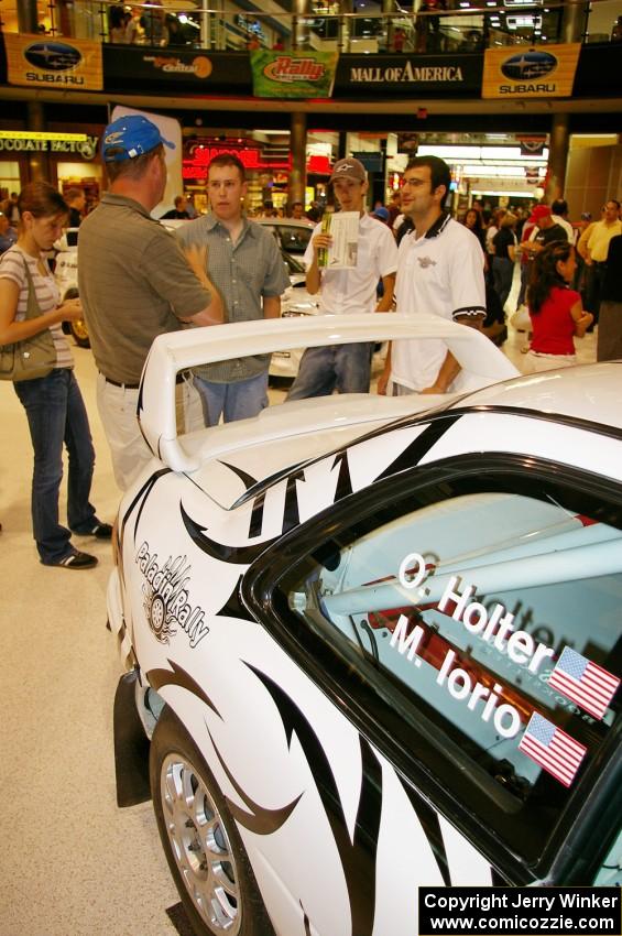 Matt Iorio discusses his Subaru Impreza to new rally fans at the Mall of America. Ole Holter was his navigator for the weekend.