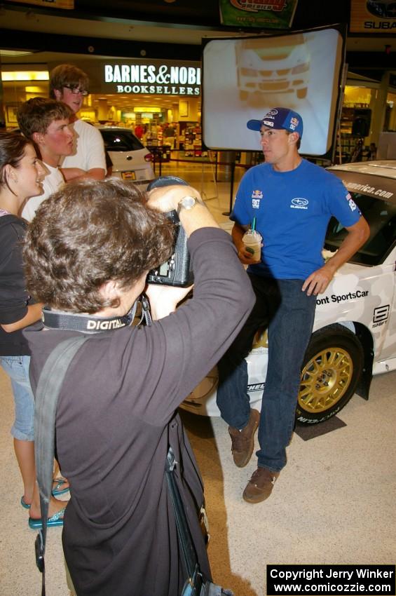 Travis Pastrana poses for the press in front of the Ken Block / Alex Gelsomino Subaru WRX STi.