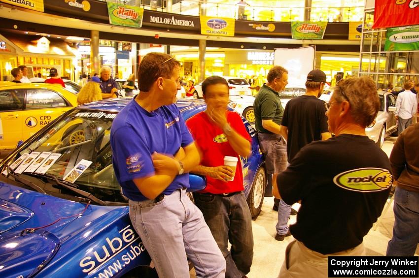 Scott Putnam, Pat Richard, and Pat's father converse over coffee at the Mall of America.