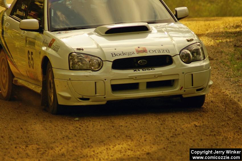 Stig Blomqvist / Ana Goni at speed through a fast left-hander on Halverson Lake, SS1, in their Subaru WRX STi.