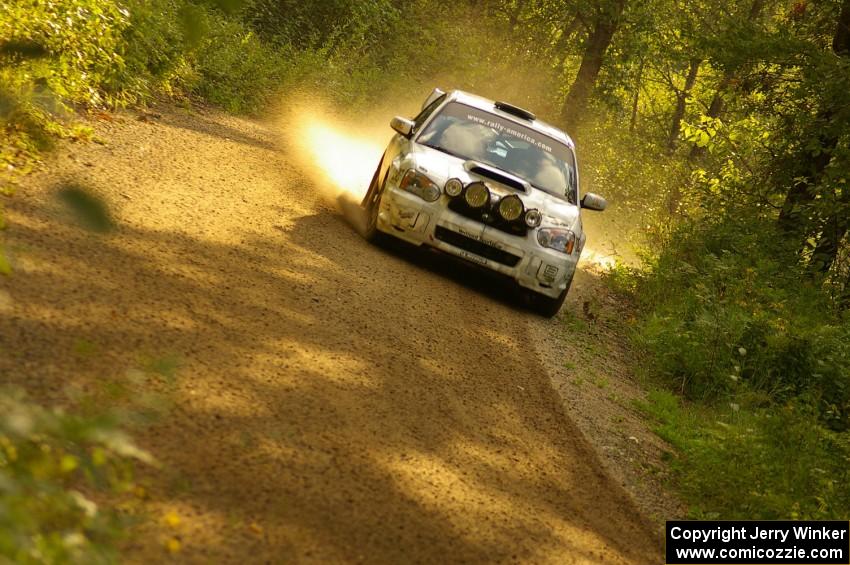 Ken Block / Alex Gelsomino Subaru WRX STi at speed through a fast left-hand sweeper on SS1, Halverson Lake.