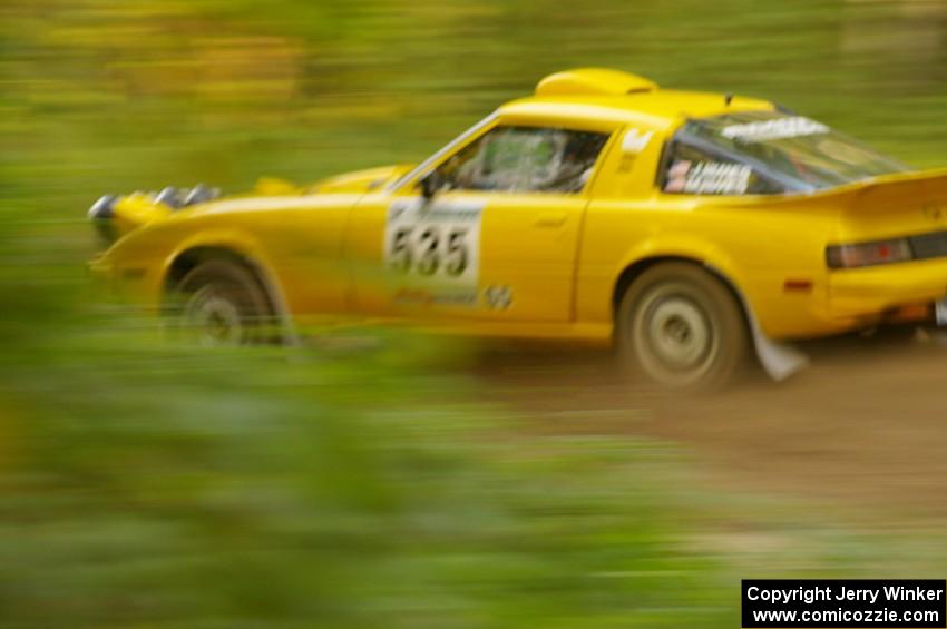 Jake Himes / Matt Himes Mazda RX-7 at speed down a straight on Halverson Lake, SS1.