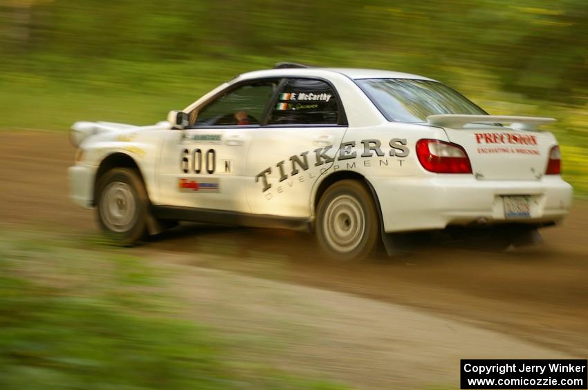 Fintan McCarthy / Noel Gallagher Subaru WRX STi at speed down a straight on Halverson Lake, SS1.