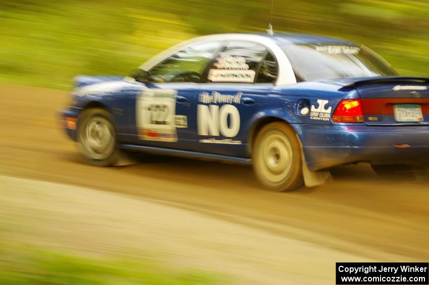 Dennis Martin / Kim DeMotte Saturn SL2 at speed down a straight on Halverson Lake, SS1.