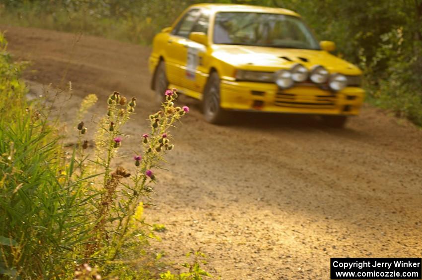 Erik Payeur / Adam Payeur Mitsubishi Galant blasts past a cluster of thistles through the final corner of Halverson Lake, SS1.