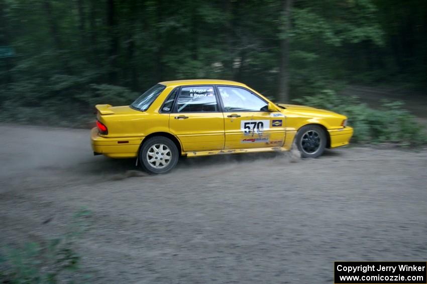 Erik Payeur / Adam Payeur Mitsubishi Galant clips the inside of a hairpin too close on SS1 and gets hung up on a boulder.