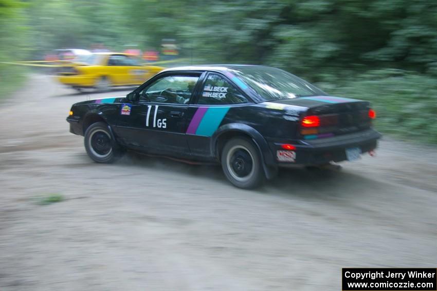 Jason Beck / Harry Beck Pontiac Sunbird at speed on SS1 as the Erik Payeur / Adam Payeur Mitsubishi Galant gets turned around.