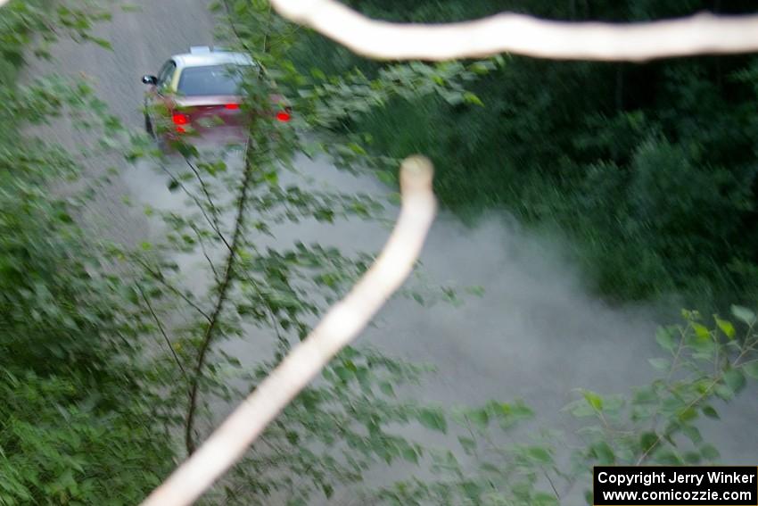 Scott Parrott / Breon Nagy Plymouth Neon at speed on a straight on SS2 just before sundown.