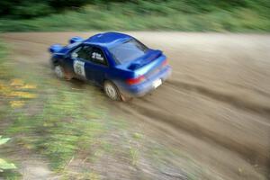 Bob Olson / Conrad Ketelson Subaru 2.5RS at speed through a fast uphill left-hander on SS2, Spur 2.