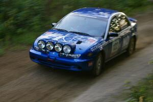 Dennis Martin / Kim DeMotte Saturn SL2 at speed through a fast uphill section of SS2, Spur 2.