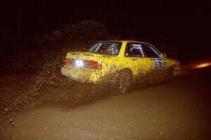 Erik Payeur / Adam Payeur Mitsubishi Galant slings gravel through a 90-left on SS7, Blue Trail.