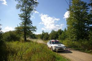 Chris Gilligan / Joe Petersen Mitsubishi Lancer Evo IV at speed through the picturesque White Earth State Forest.