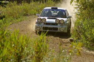 Fintan McCarthy / Noel Gallagher Subaru WRX STi at speed through a downhill left on SS10, Chad's Yump.