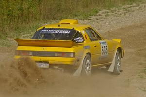 Jake Himes / Matt Himes Mazda RX-7 sprays gravel through an uphill right on SS10, Chad's Yump.