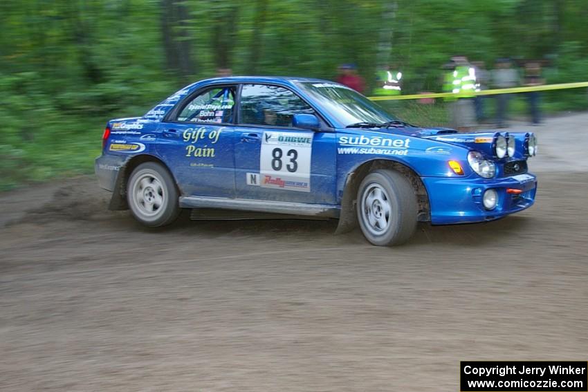 Mark Utecht / Rob Bohn Subaru WRX drifts wide at a 90-right on SS2, Spur 2.