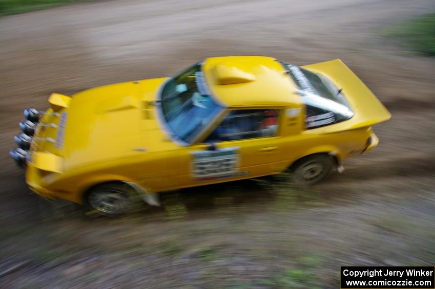 Jake Himes / Matt Himes Mazda RX-7 at speed through an uphill left-hand sweeper on SS2, Spur 2.