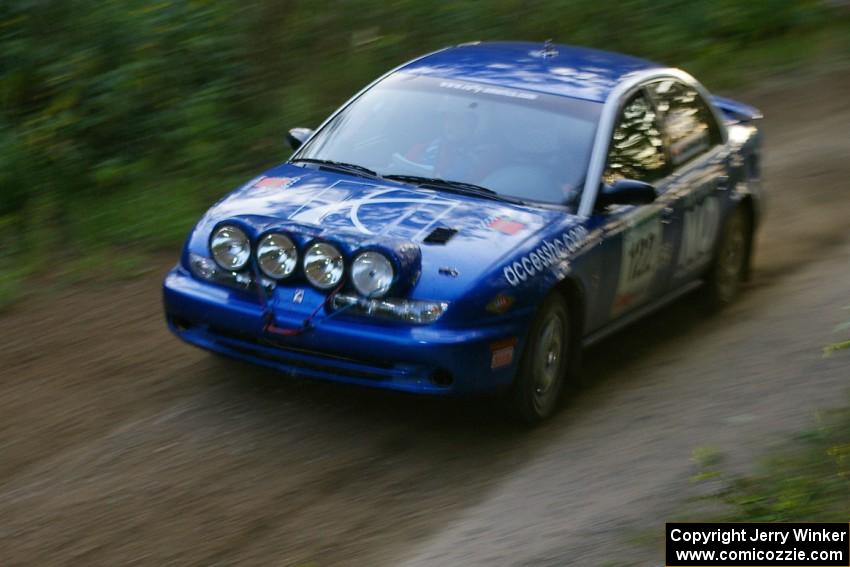 Dennis Martin / Kim DeMotte Saturn SL2 at speed through a fast uphill section of SS2, Spur 2.