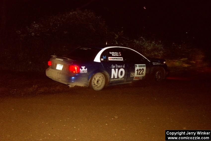 Dennis Martin / Kim DeMotte Saturn SL2 drifts through a 90-left on SS7, Blue Trail.