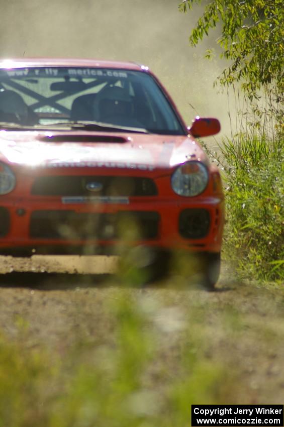 Matthew Johnson / Wendy Nakamoto Subaru WRX at speed on SS10, Chad's Yump.