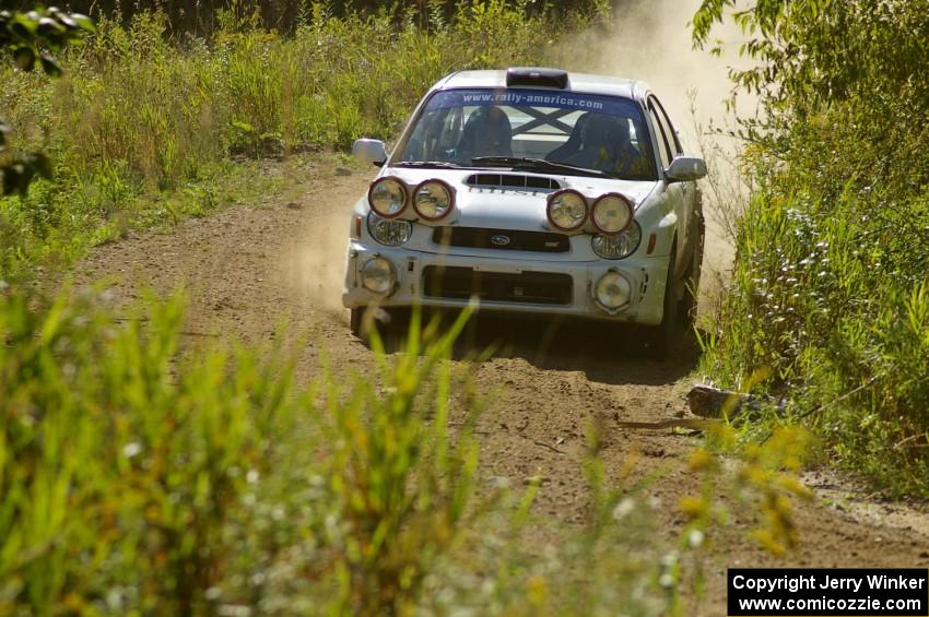 Fintan McCarthy / Noel Gallagher Subaru WRX STi at speed through a downhill left on SS10, Chad's Yump.
