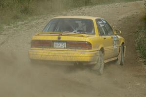 Erik Payeur / Adam Payeur Mitsubishi Galant drifts uphill through the dust on SS10, Chad's Yump.