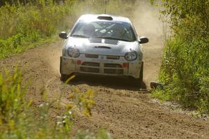 Bruce Davis / Jimmy Brandt Dodge SRT-4 drift through a fast left-hand sweeper on SS10, Chad's Yump.