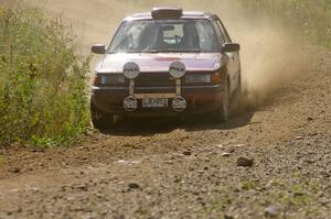 Ben Hanka / John Nordlie Mazda Protege through an uphill left on SS10, Chad's Yump.